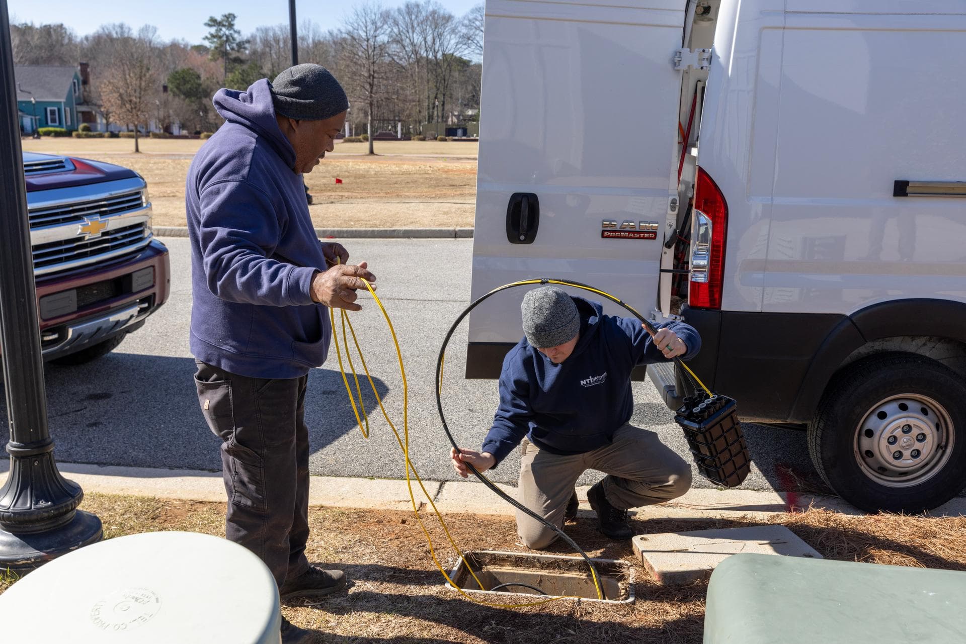 Norvet MSP technicians pulling fiber cable from service van at The District